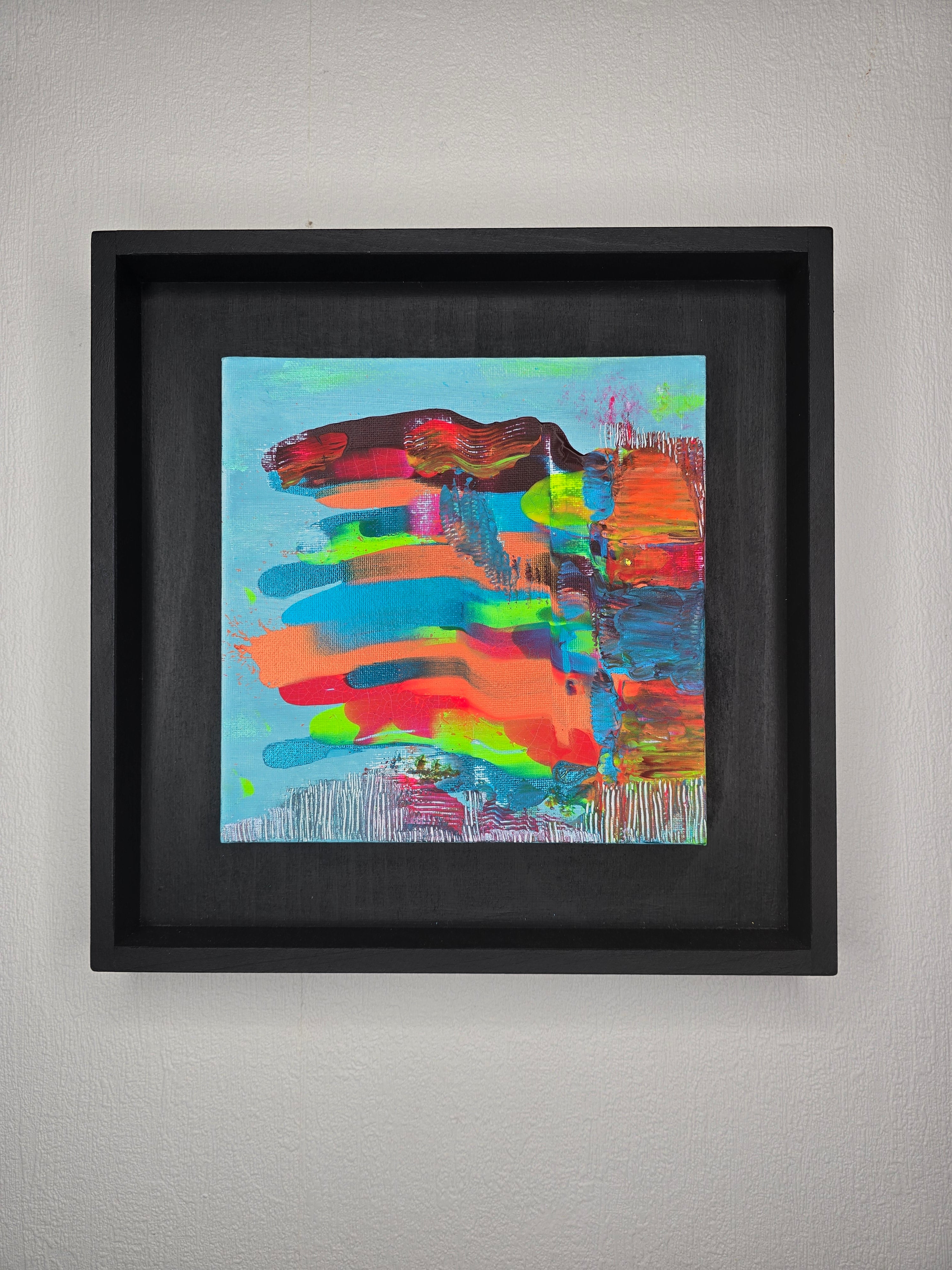 Petit tableau peinture abstrait carré Écrin Néon™ aux couleurs turquoise orange rose et bleu avec cadre noir contemporain